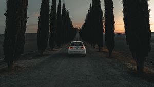 Preview wallpaper car, road, trees, alley, twilight