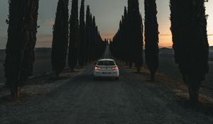 Preview wallpaper car, road, trees, alley, twilight