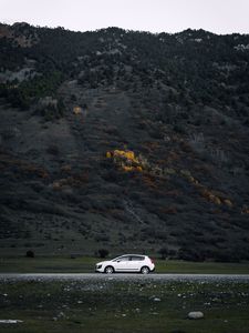 Preview wallpaper car, side view, mountains, slope, road