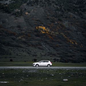 Preview wallpaper car, side view, mountains, slope, road