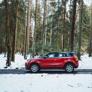 Preview wallpaper car, side view, red, road, forest, snowy