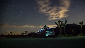 Preview wallpaper car, starry sky, man, loneliness, palm trees, solitude