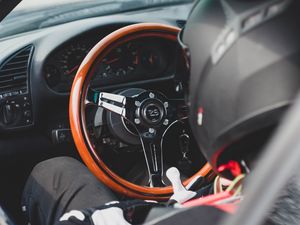 Preview wallpaper car, steering wheel, racer, helmet, salon