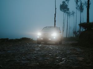 Preview wallpaper car, suv, fog, light, twilight