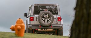 Preview wallpaper car, suv, gray, tree, field, hydrant