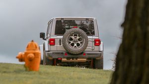 Preview wallpaper car, suv, gray, tree, field, hydrant