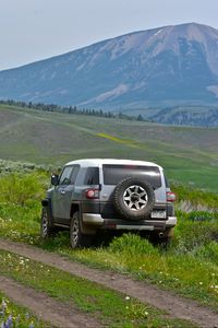 Preview wallpaper car, suv, gray, field, path