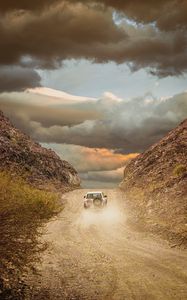 Preview wallpaper car, suv, road, dust, sky