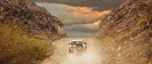 Preview wallpaper car, suv, road, dust, sky