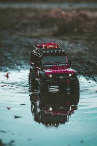 Preview wallpaper car, suv, toy, red, puddle