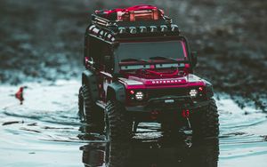 Preview wallpaper car, suv, toy, red, puddle