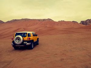 Preview wallpaper car, suv, yellow, desert, sand
