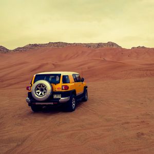 Preview wallpaper car, suv, yellow, desert, sand