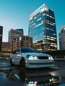 Preview wallpaper car, white, city, buildings