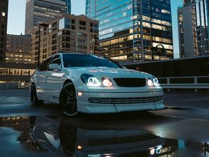 Preview wallpaper car, white, city, buildings