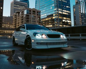 Preview wallpaper car, white, city, buildings