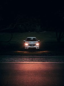 Preview wallpaper car, white, light, headlights, front view, dark