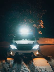 Preview wallpaper car, white, lights, light, snow, winter