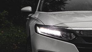 Preview wallpaper car, white, wet, headlight, light, front view