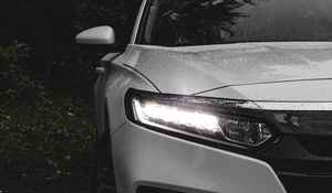 Preview wallpaper car, white, wet, headlight, light, front view