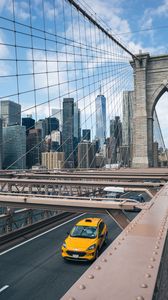 Preview wallpaper car, yellow, bridge, city, buildings