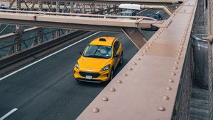 Preview wallpaper car, yellow, bridge, city, buildings