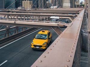 Preview wallpaper car, yellow, bridge, city, buildings