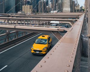 Preview wallpaper car, yellow, bridge, city, buildings