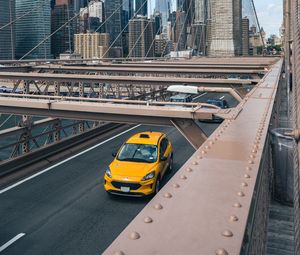 Preview wallpaper car, yellow, bridge, city, buildings