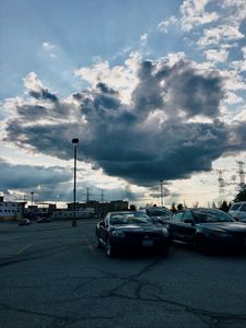 Preview wallpaper cars, city, evening, clouds