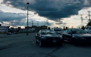 Preview wallpaper cars, city, evening, clouds