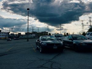 Preview wallpaper cars, city, evening, clouds