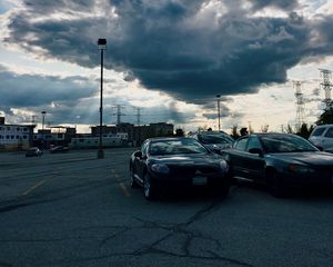 Preview wallpaper cars, city, evening, clouds