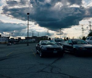 Preview wallpaper cars, city, evening, clouds