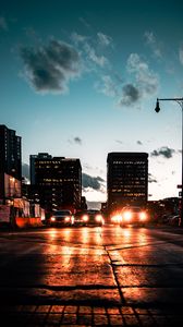 Preview wallpaper cars, headlights, light, road, buildings, twilight