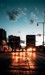 Preview wallpaper cars, headlights, light, road, buildings, twilight