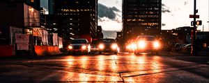 Preview wallpaper cars, headlights, light, road, buildings, twilight