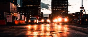 Preview wallpaper cars, headlights, light, road, buildings, twilight