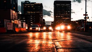 Preview wallpaper cars, headlights, light, road, buildings, twilight