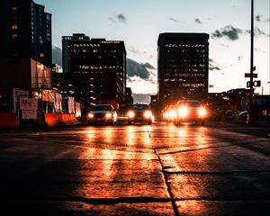 Preview wallpaper cars, headlights, light, road, buildings, twilight