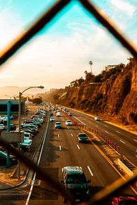 Preview wallpaper cars, road, parking, rocks, fence