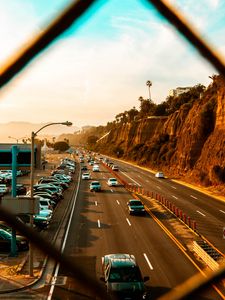 Preview wallpaper cars, road, parking, rocks, fence