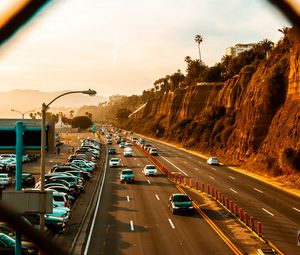 Preview wallpaper cars, road, parking, rocks, fence