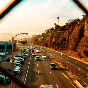 Preview wallpaper cars, road, parking, rocks, fence