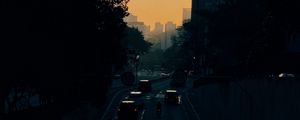 Preview wallpaper cars, road, sunset, architecture, branches, movement