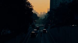 Preview wallpaper cars, road, sunset, architecture, branches, movement