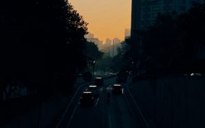 Preview wallpaper cars, road, sunset, architecture, branches, movement