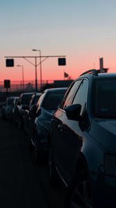 Preview wallpaper cars, sunset, traffic, sky