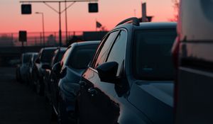 Preview wallpaper cars, sunset, traffic, sky