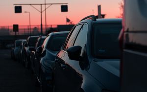 Preview wallpaper cars, sunset, traffic, sky